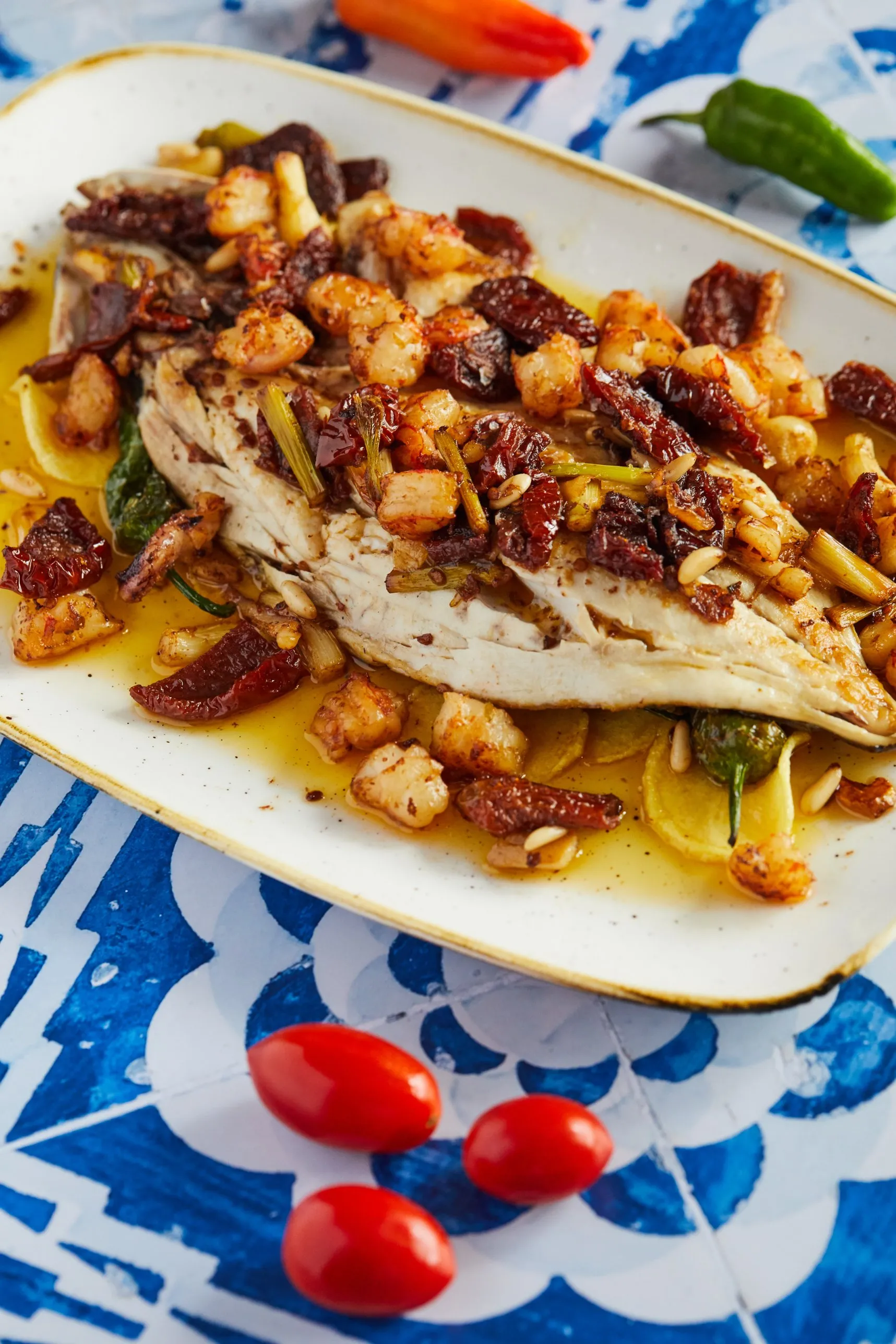 Fish with prawns, sun-dried tomato and pine nuts