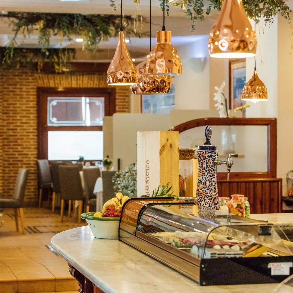 Restaurant bar with display counter and copper lamps